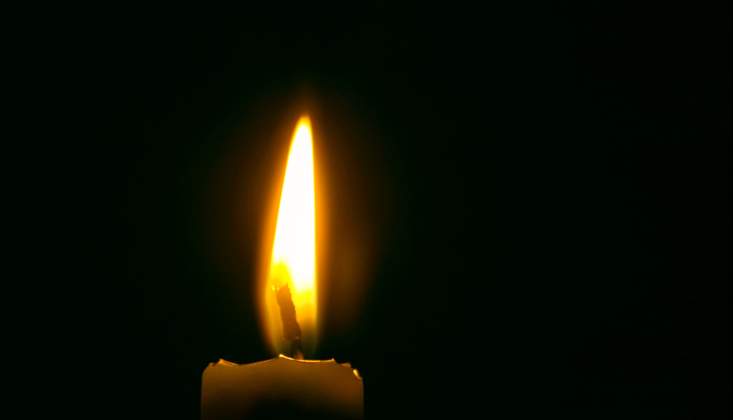 attēls melns ar degošu sveci fonā